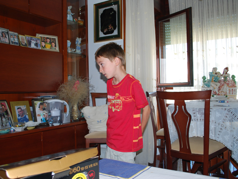 Xabi in Amama's flat looking at family photos - August 2008